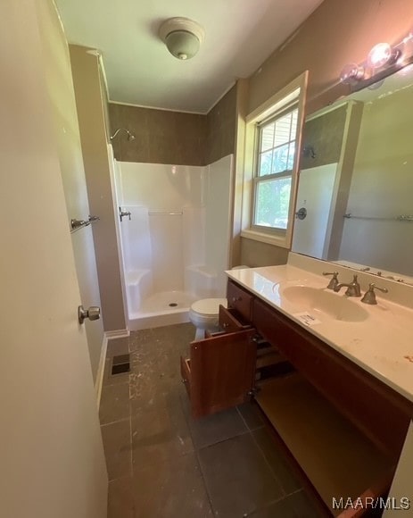 323 E Highland St, Dadeville, AL 36853 - full bath with a stall shower, tile patterned floors, and vanity