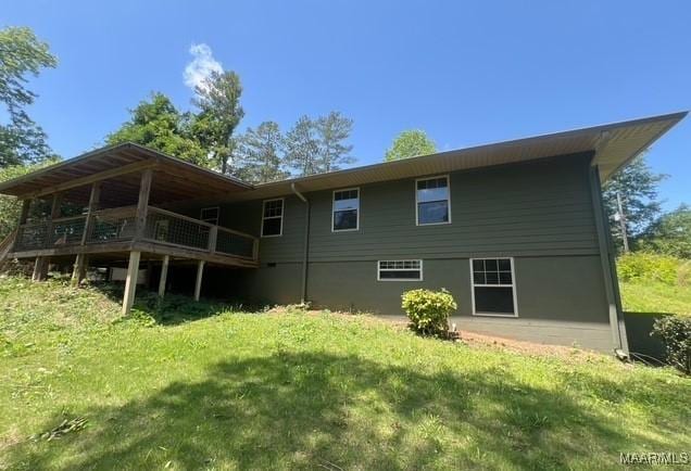 323 E Highland St, Dadeville, AL 36853 - rear view of house with a yard