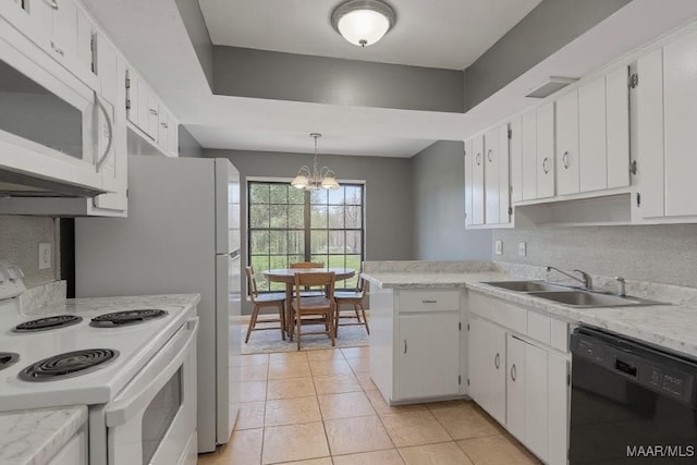 508 Ridgewood Ln, Montgomery, AL 36109 - kitchen with white appliances, light countertops, white cabinets, a chandelier, and light tile patterned floors