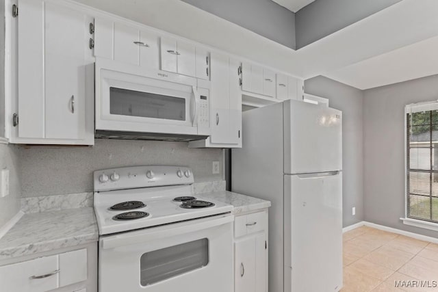 508 Ridgewood Ln, Montgomery, AL 36109 - kitchen featuring white appliances, white cabinets, healthy amount of natural light, and light tile patterned floors