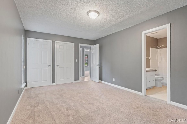 508 Ridgewood Ln, Montgomery, AL 36109 - unfurnished bedroom featuring carpet, a textured ceiling, two closets, and ensuite bathroom