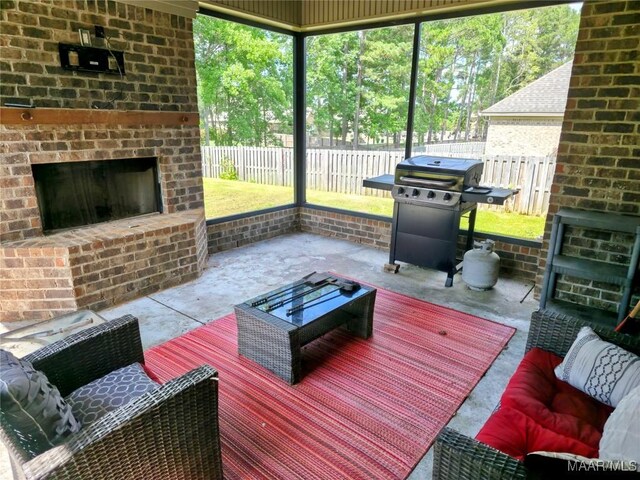 134 Southern Hills Rdg, Wetumpka, AL 36093 - deck featuring grilling area, a fenced backyard, an outdoor living space with a fireplace, and a patio area