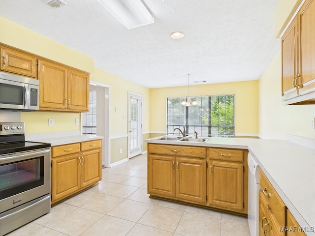 508 Mossy Oak Rdg, Prattville, AL 36066 - kitchen with appliances with stainless steel finishes, light countertops, a peninsula, light tile patterned floors, and a textured ceiling