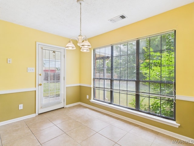 508 Mossy Oak Rdg, Prattville, AL 36066 - unfurnished dining area featuring a chandelier, light tile patterned floors, and a textured ceiling