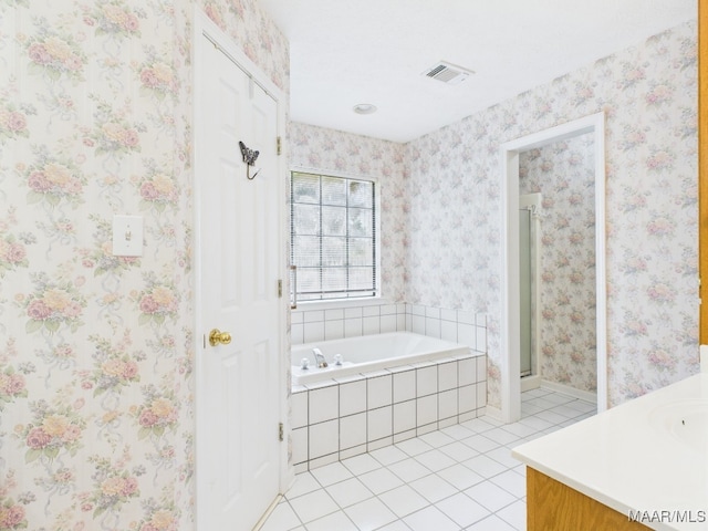 508 Mossy Oak Rdg, Prattville, AL 36066 - bathroom featuring tile patterned floors, vanity, a garden tub, and a shower stall