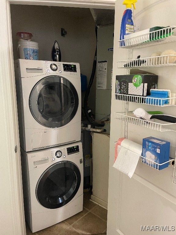 1061 Stonegate Dr Unit C, Auburn, AL 36832 - washroom with stacked washer and clothes dryer and tile patterned flooring