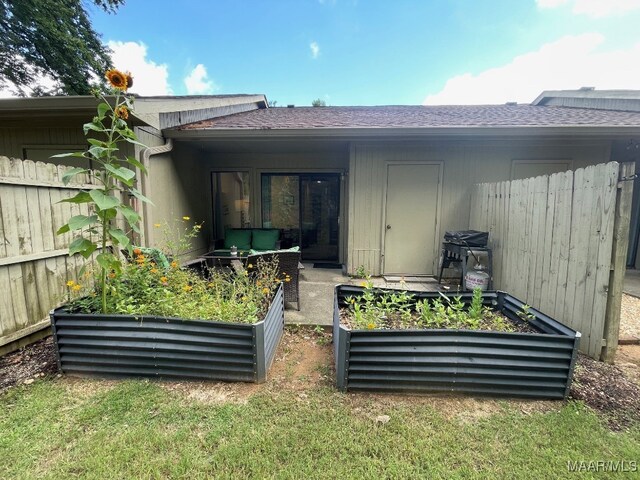 1061 Stonegate Dr Unit C, Auburn, AL 36832 - back of property featuring a garden and a shingled roof