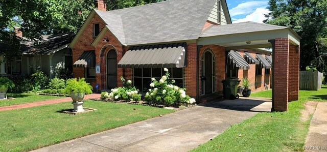 1928 Winona Ave, Montgomery, AL 36107 - view of front of home featuring brick siding, a front lawn, driveway, and a shingled roof