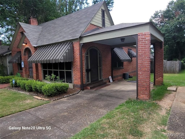 1928 Winona Ave, Montgomery, AL 36107 - view of front of property with brick siding, a chimney, a shingled roof, and driveway