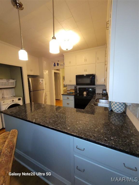 1928 Winona Ave, Montgomery, AL 36107 - kitchen featuring black appliances, washer / dryer, white cabinetry, tasteful backsplash, and dark stone counters