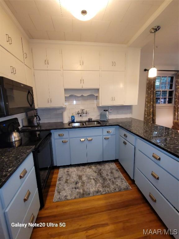 1928 Winona Ave, Montgomery, AL 36107 - kitchen with black appliances, dark wood-style floors, white cabinetry, and tasteful backsplash