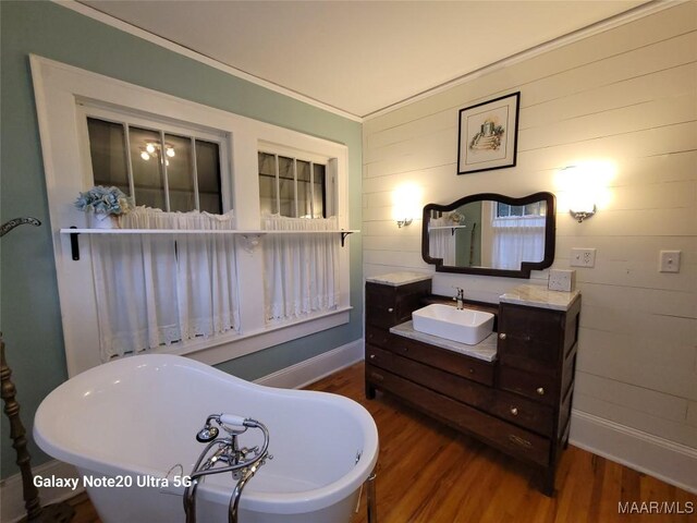 1928 Winona Ave, Montgomery, AL 36107 - bathroom featuring wood finished floors, a freestanding tub, and vanity