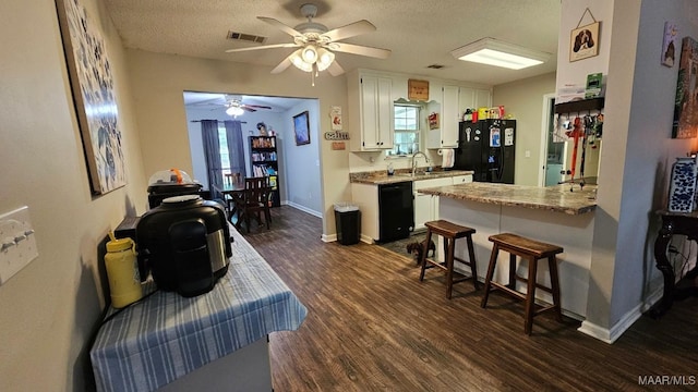1345 Firetower Rd, Wetumpka, AL 36092 - kitchen featuring black appliances, white cabinetry, a ceiling fan, dark wood-style floors, and a textured ceiling