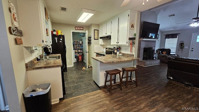 1345 Firetower Rd, Wetumpka, AL 36092 - kitchen with ceiling fan, electric range, open floor plan, under cabinet range hood, and white cabinetry