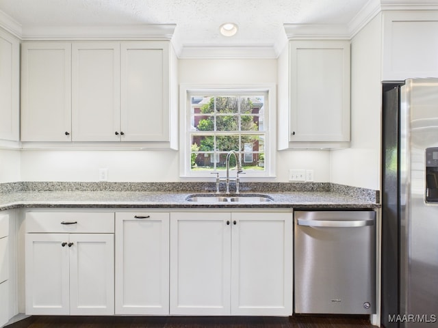 327 County Downs Rd, Montgomery, AL 36109 - kitchen featuring stainless steel appliances, white cabinetry, dark stone counters, and ornamental molding