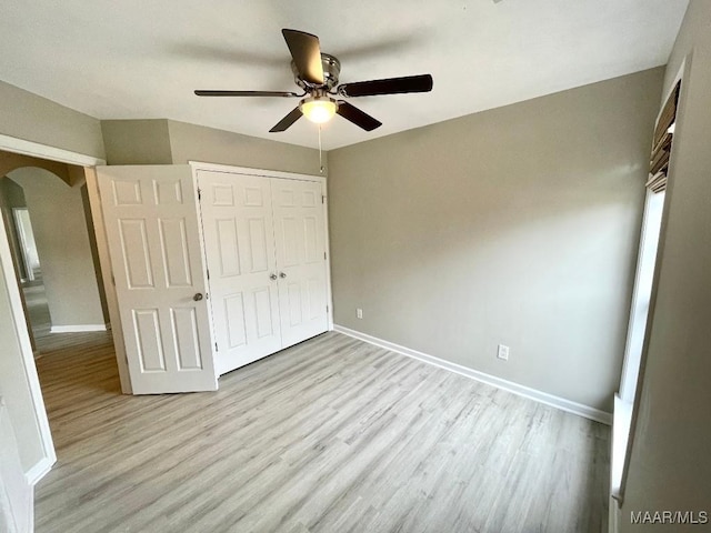 2495 Chancellor Ridge Rd, Prattville, AL 36066 - unfurnished bedroom with arched walkways, wood finished floors, a closet, and ceiling fan