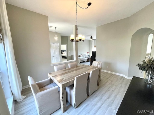 2495 Chancellor Ridge Rd, Prattville, AL 36066 - dining room with arched walkways, light wood-style floors, and a chandelier