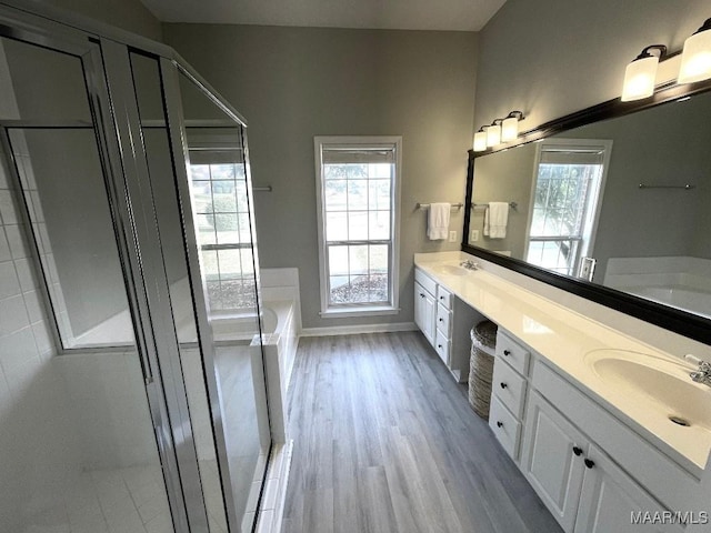 2495 Chancellor Ridge Rd, Prattville, AL 36066 - bathroom featuring double vanity, a bath, wood finished floors, and healthy amount of natural light