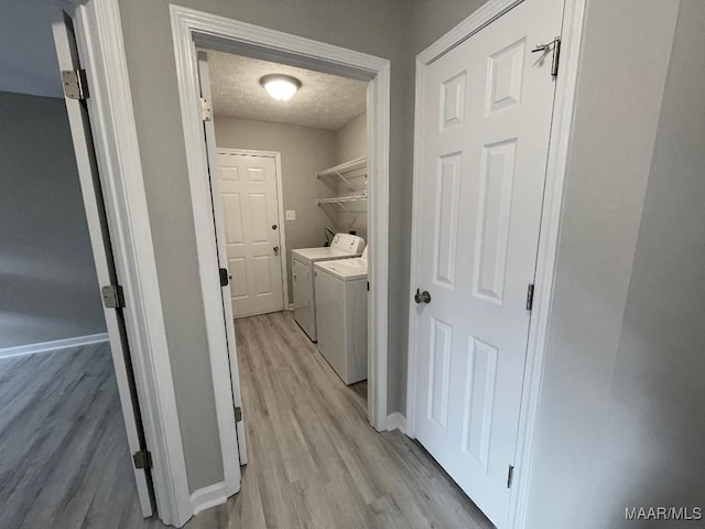 2495 Chancellor Ridge Rd, Prattville, AL 36066 - washroom with light wood-type flooring, washer and dryer, and a textured ceiling