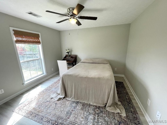 2495 Chancellor Ridge Rd, Prattville, AL 36066 - bedroom featuring a textured ceiling, wood finished floors, and ceiling fan