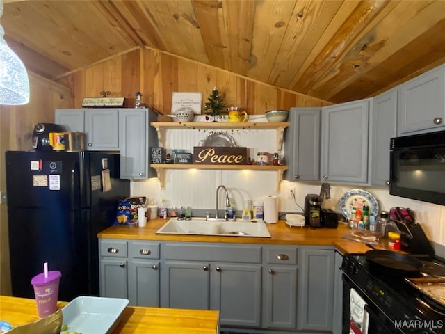 1651 Tawassee Pointe Dr, Lowndesboro, AL 36752 - kitchen with black appliances, vaulted ceiling, open shelves, wood walls, and gray cabinetry