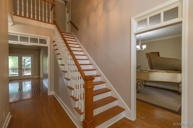 240 Winding Wood Dr, Wetumpka, AL 36093 - staircase featuring wood finished floors, ornamental molding, french doors, and a chandelier