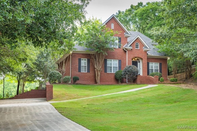 240 Winding Wood Dr, Wetumpka, AL 36093 - traditional-style house with brick siding, a front lawn, and roof with shingles