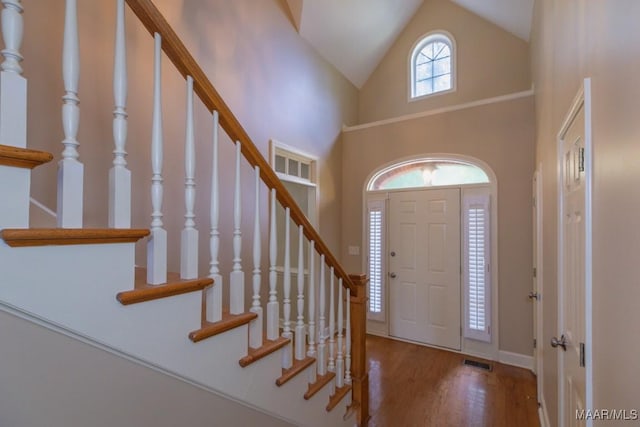 240 Winding Wood Dr, Wetumpka, AL 36093 - entrance foyer with wood finished floors, high vaulted ceiling, and stairway