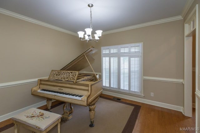 240 Winding Wood Dr, Wetumpka, AL 36093 - living area featuring a chandelier, wood finished floors, and crown molding