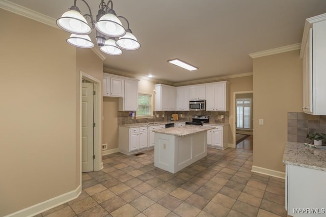 240 Winding Wood Dr, Wetumpka, AL 36093 - kitchen with stainless steel microwave, decorative backsplash, black / electric stove, white cabinets, and ornamental molding