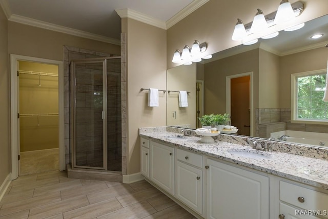 240 Winding Wood Dr, Wetumpka, AL 36093 - full bathroom featuring a stall shower, double vanity, ornamental molding, a spacious closet, and a bath