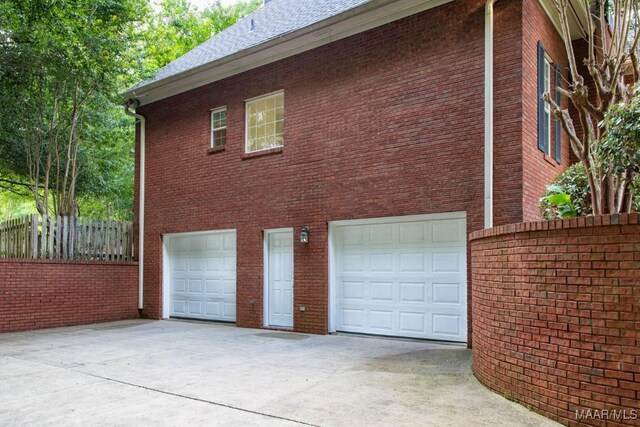 240 Winding Wood Dr, Wetumpka, AL 36093 - view of side of home with driveway, an attached garage, and brick siding