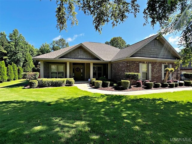 309 Southern Hills Dr, Wetumpka, AL 36093 - view of front facade featuring a front lawn, brick siding, a porch, and roof with shingles