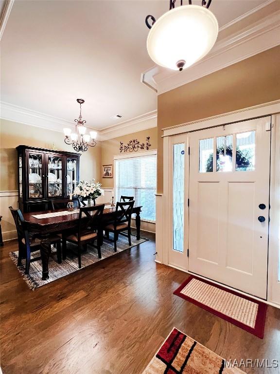 309 Southern Hills Dr, Wetumpka, AL 36093 - entrance foyer with dark wood-style flooring, a chandelier, ornamental molding, and a wainscoted wall