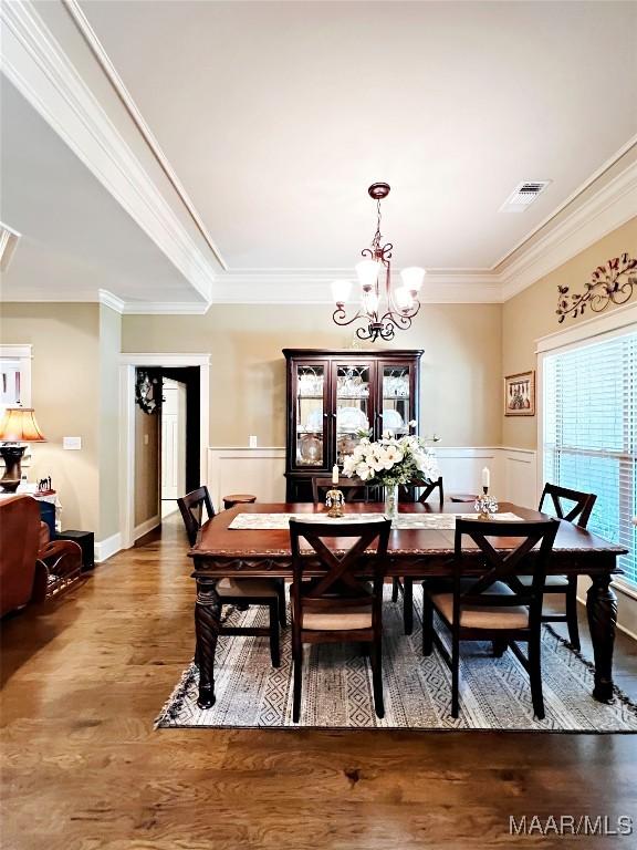 309 Southern Hills Dr, Wetumpka, AL 36093 - dining area with a chandelier, crown molding, a wainscoted wall, and wood finished floors