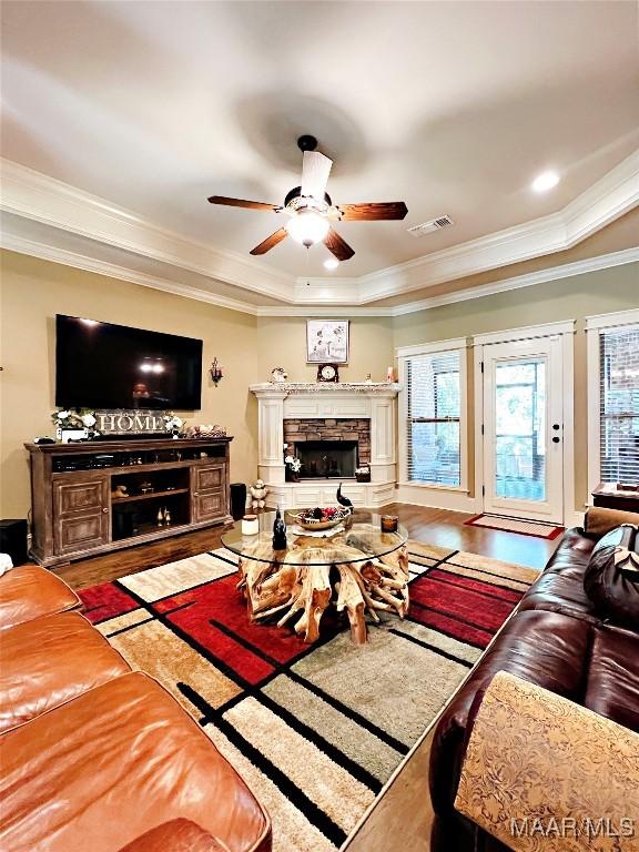 309 Southern Hills Dr, Wetumpka, AL 36093 - living area with wood finished floors, ceiling fan, a fireplace, ornamental molding, and a tray ceiling