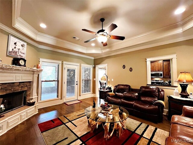 309 Southern Hills Dr, Wetumpka, AL 36093 - living room featuring a tray ceiling, ceiling fan, crown molding, wood finished floors, and a fireplace