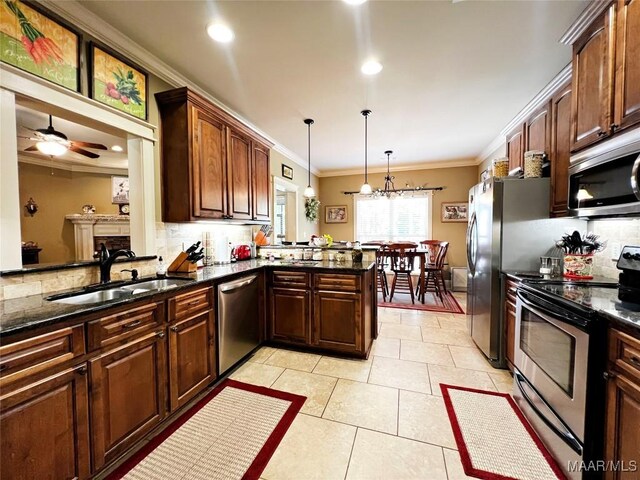 309 Southern Hills Dr, Wetumpka, AL 36093 - kitchen with appliances with stainless steel finishes, backsplash, crown molding, a peninsula, and pendant lighting