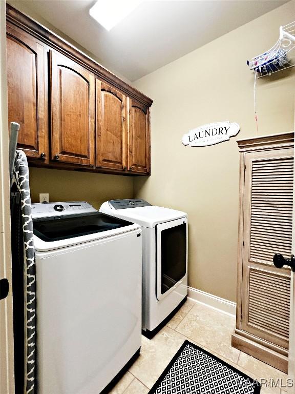 309 Southern Hills Dr, Wetumpka, AL 36093 - laundry room with washing machine and clothes dryer, cabinet space, and light tile patterned floors