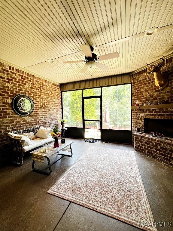 309 Southern Hills Dr, Wetumpka, AL 36093 - living area with brick wall, healthy amount of natural light, ceiling fan, wood ceiling, and a fireplace