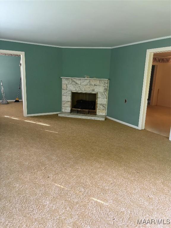 407 Powers Ave, Tallassee, AL 36078 - unfurnished living room featuring crown molding, carpet floors, and a fireplace