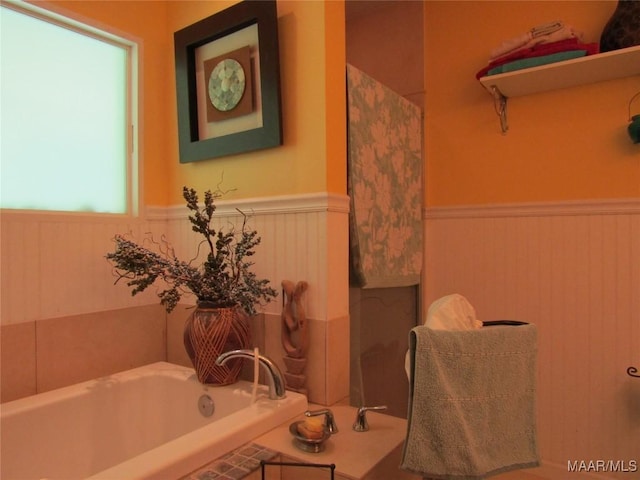 1716 Old Federal Rd, Shorter, AL 36075 - bathroom featuring a wainscoted wall and a bath