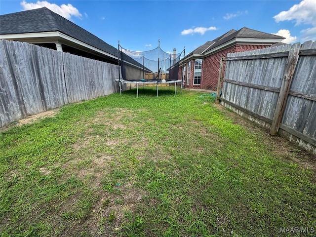 1312 Centerfield Ct, Montgomery, AL 36117 - fenced backyard featuring a trampoline