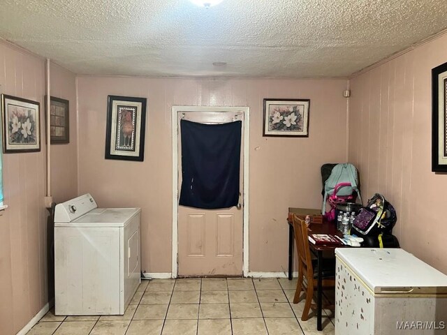530 Brookview Dr, Montgomery, AL 36110 - laundry area featuring washer / clothes dryer, light tile patterned floors, a textured ceiling, and wooden walls