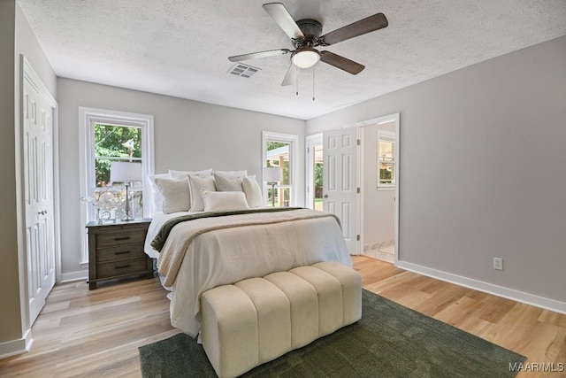 5010 Redland Rd, Wetumpka, AL 36093 - bedroom with light wood-style floors, a textured ceiling, and ceiling fan
