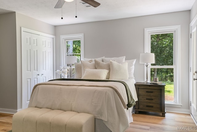 5010 Redland Rd, Wetumpka, AL 36093 - bedroom with light wood finished floors, a closet, and a ceiling fan