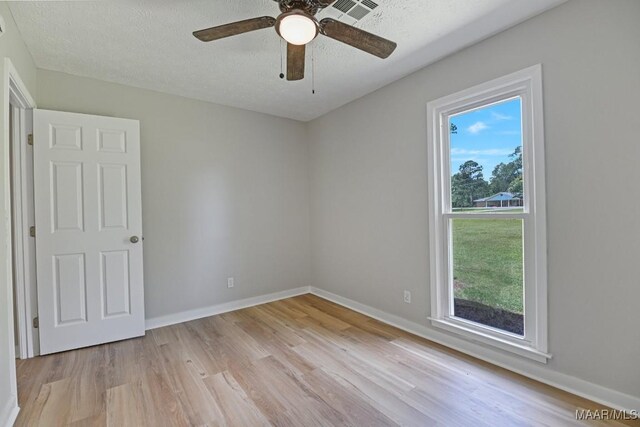 5010 Redland Rd, Wetumpka, AL 36093 - empty room with light wood finished floors, a textured ceiling, and ceiling fan