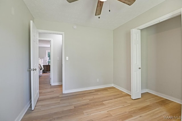 5010 Redland Rd, Wetumpka, AL 36093 - unfurnished bedroom with light wood-type flooring, a ceiling fan, and a textured ceiling