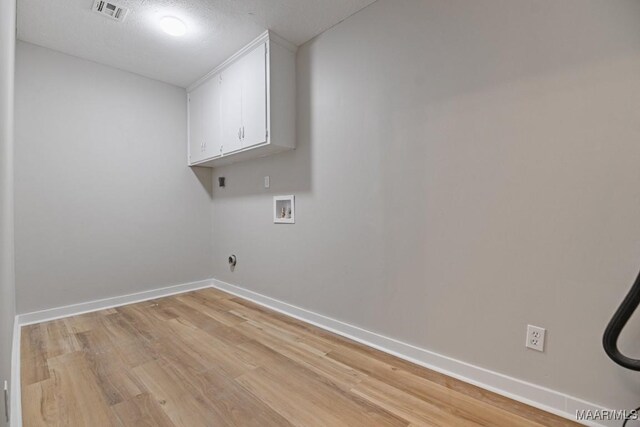 5010 Redland Rd, Wetumpka, AL 36093 - washroom featuring cabinet space, light wood-style flooring, and washer hookup