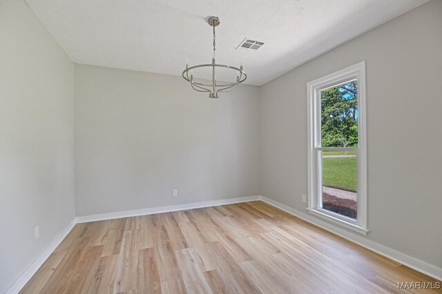 5010 Redland Rd, Wetumpka, AL 36093 - unfurnished room featuring a chandelier and light wood-style floors